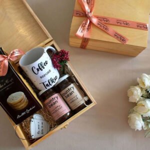 a hamper of coffee cups, coffee beans and cookies